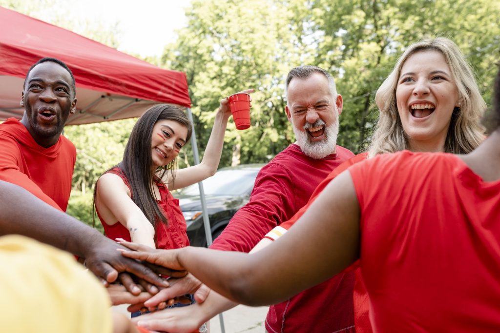 Street team brand activation with energetic group of people huddling at a branded outdoor event