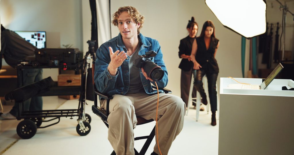 Creative team working in a video production agency studio preparing social media and commercial video content