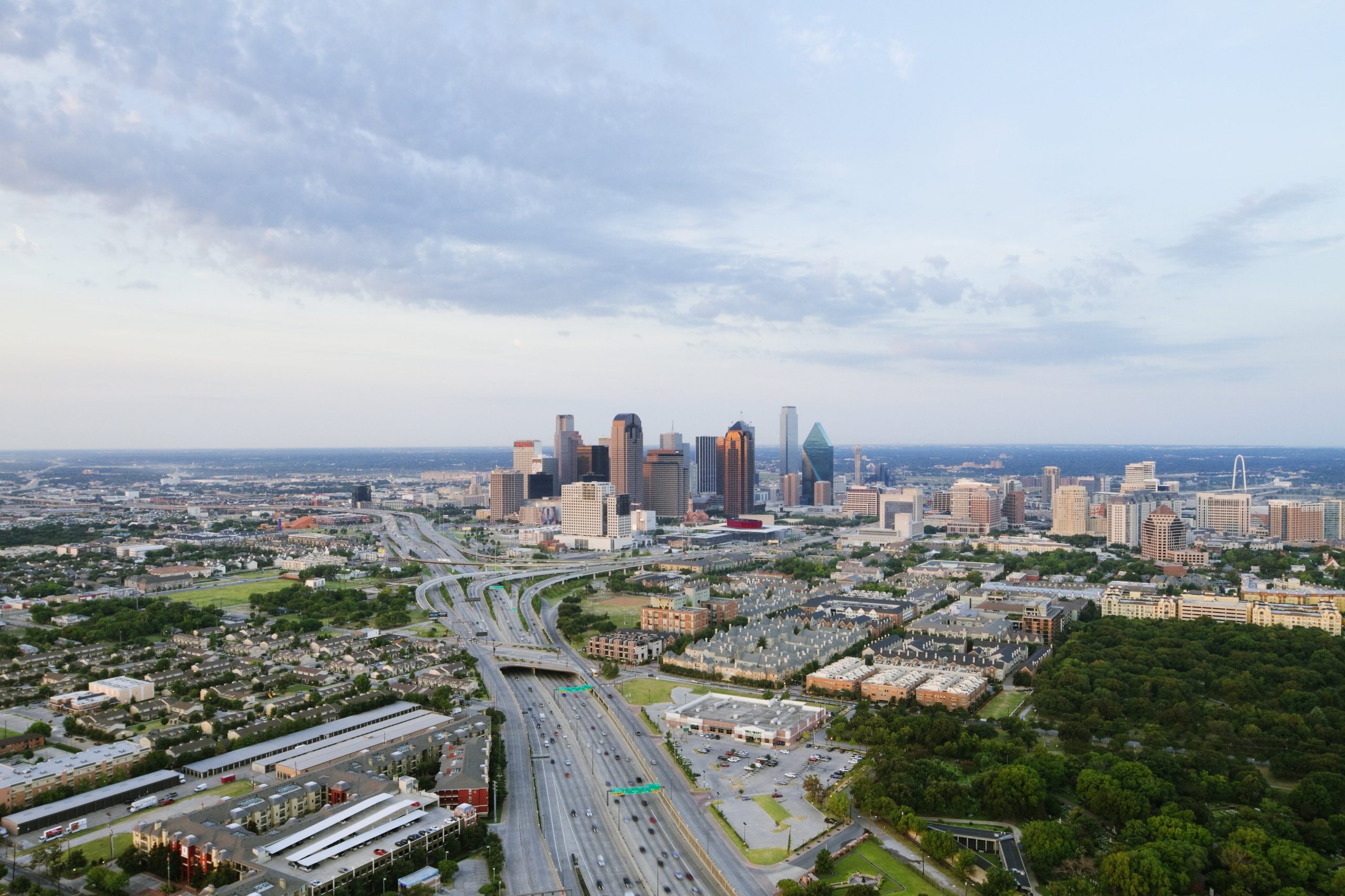 Daytime aerial view of the Dallas skyline with highways leading into the city, representing top digital marketing agencies in Dallas–Fort Worth
