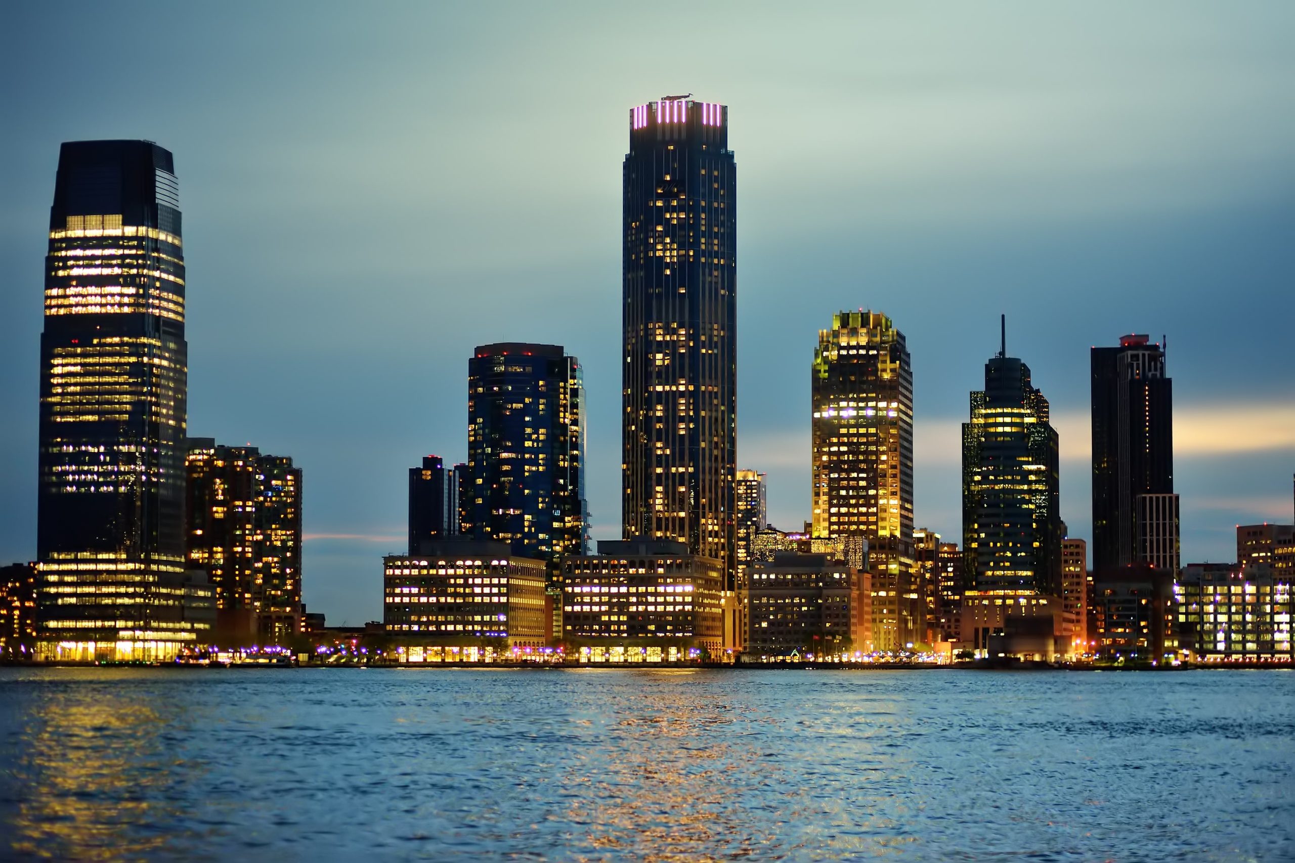 Night view of New Jersey city skyline along the Hudson River, representing top digital marketing agencies in New Jersey for 2025